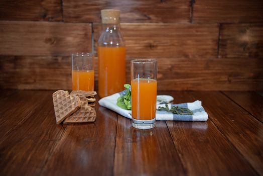 Fitness breakfast with freshly squeezed juice and wafers on wooden background. Proper nutrition theme