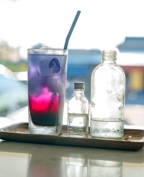 Butterfly pea ice cube server with soda water