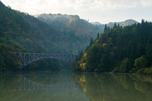 Autumn fall foliage Fukushima First Bridge daiichi kyouryou from Tadami River bank  in Mishima Fukushima Japan