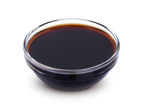 Soy sauce in bowl isolated on white background with clipping path. Top view