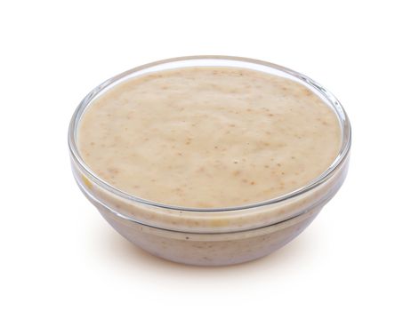 Sesame sauce. Tahini in bowl isolated on white background with clipping path