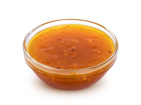 Sweet and sour sauce in bowl isolated on white background with clipping path