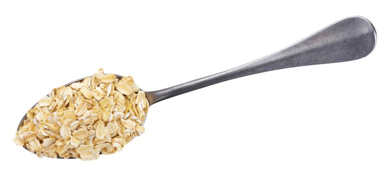 Oat flakes in spoon isolated on white background with clipping path. Top view