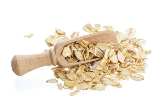 Oat flakes in wooden scoop isolated on white background. Close up.