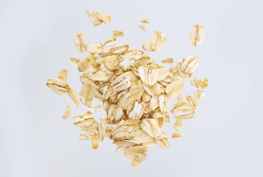 Oat flakes isolated on white background. Top view. Close up.