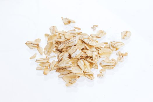 Oat flakes isolated on white background. Top view. Close up.
