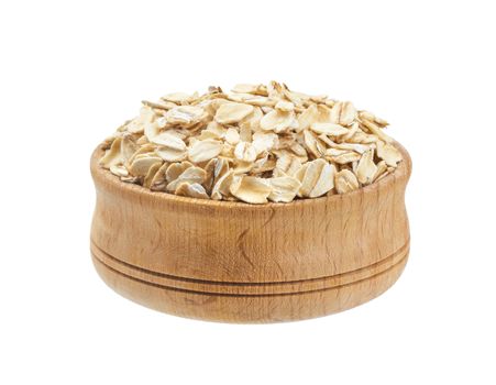 Isolated oatmeal. Oat flakes in wooden bowl on white background
