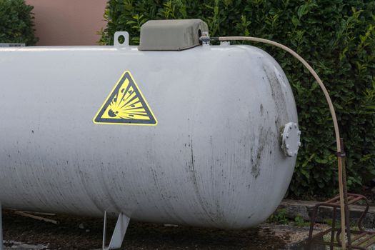 Large propane gas tank or liquid gas tank in a garden.