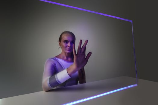 Young woman touching virtual glowing display