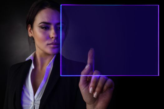 Young business woman touching virtual glowing display