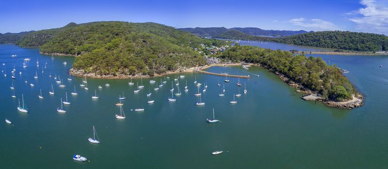 Aerial views of Brooklyn on the Hawkesbury River and its estuarine waterways and bays have many luxury yachts moored in its waters.