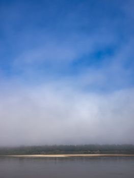 Sand bar of the Mekong River in the mist.