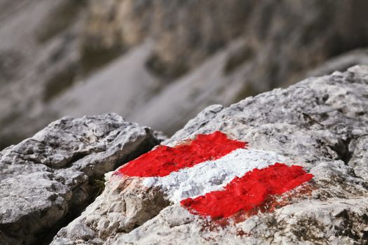 Trail mark on a stone in Dolomites, Italy