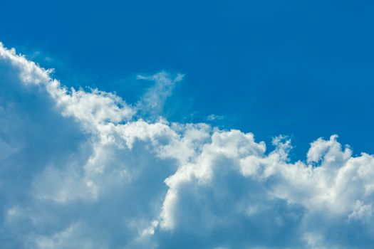 Deep blue bright sky with clouds background