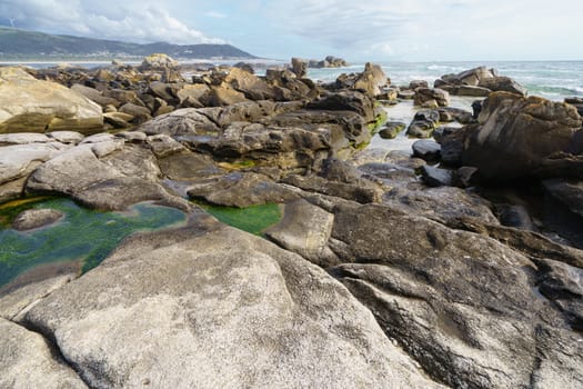 Waters of the Atlantic Ocean remained in the crevices and pits of stones after the tide