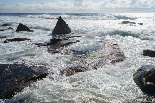 Ocean daytime landscape, giving strength. The space is filled with water, spray and ocean noise