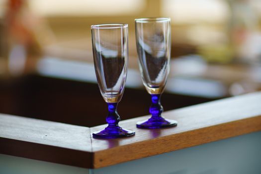 Evening at home, two empty glasses waiting for something and someone. Abstract home light bokeh defocused background