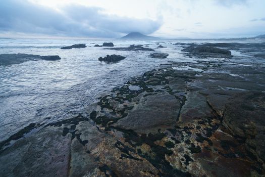 Mystical evening landscape. The ocean, sky and earth smoothly pass into each other, changing their usual colors for the magical colors