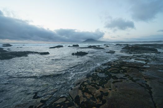 Mystical evening landscape. The ocean, sky and earth smoothly pass into each other, changing their usual colors for the magical colors