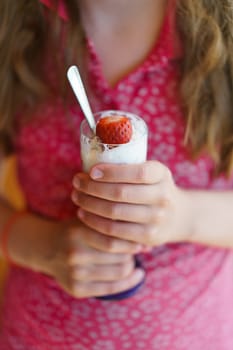 The girl holds favorite dessert in the hands