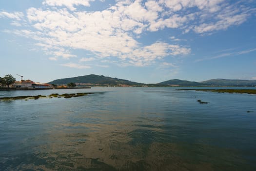 The estuary of the River Minya (northern Portugal). It flows into the Atlantic Ocean here. The place where the sky converges with the earth, clouds reflect in water