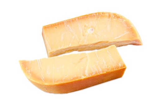 Two pieces of the Dutch hard cheese Beemster closeup on a white background
