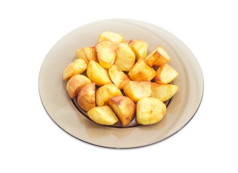 Serving of the country style fried potatoes on the dark glass dish on a light background
