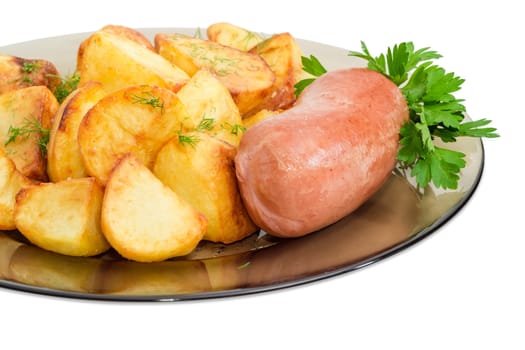 Fragment of the dark glass dish with fried potatoes sprinkled by chopped dill, fried wieners and twig of parsley closeup on a light background
