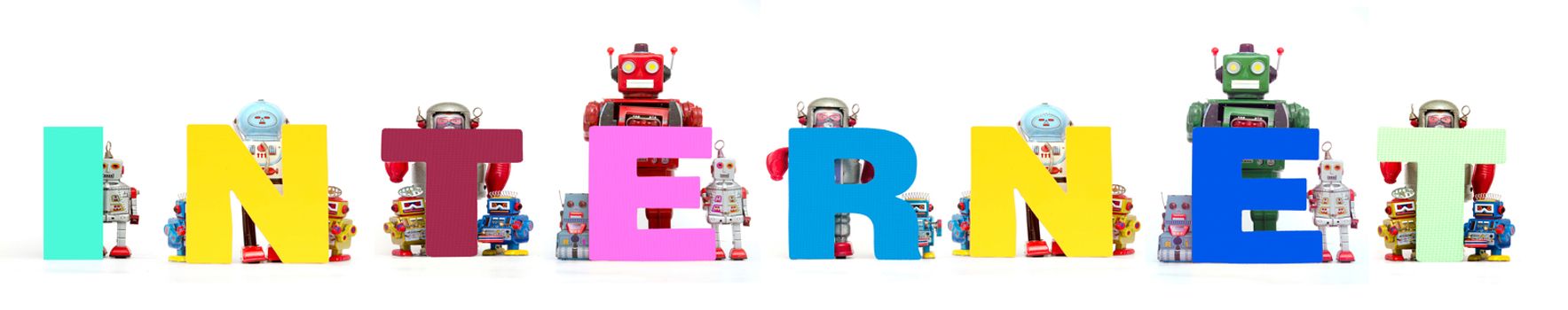 retro tin robot toys hold up the word   INTERNET solated on white banner