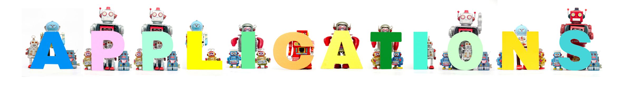 retro tin robot toys hold up the word APPLICATIONS isolated on white