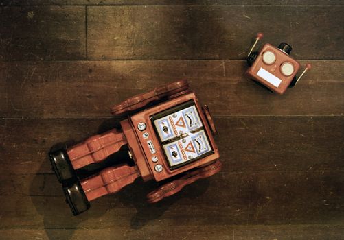 retro red robot has lost his head on a old wooden floor from above