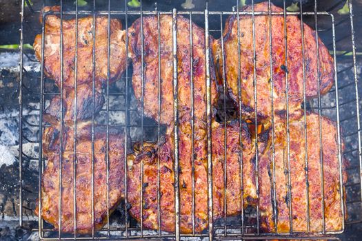 Meat fry on the grill fire. Barbecue fresh food delicious pork steak cooking