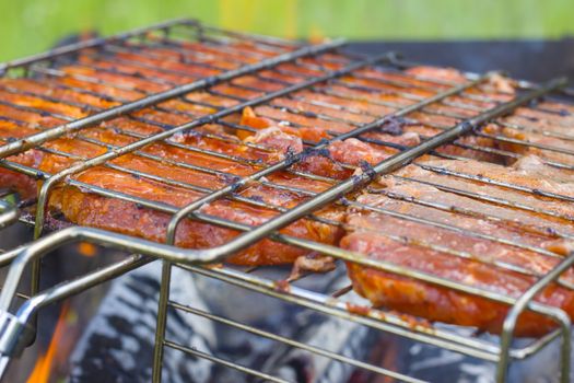 Meat steak fry on the grill fire. Barbecue fresh food delicious pork cooking on metal grid