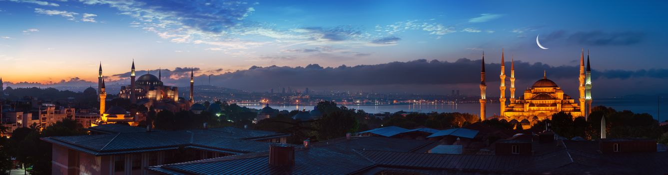 Panorama of Istanbul with the view on Blue Mosque and Hagia Sophia near Bosphorus at sunset, Turkey