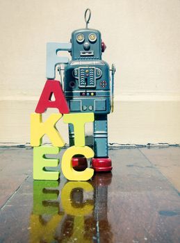wooden letters fact fake  on wooden floor and retro robot toy