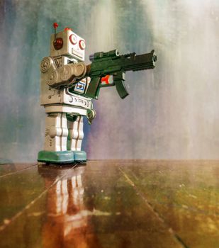 retro robot toy shoots a big gun on a wooden floor