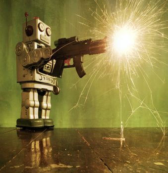 retro robot toy shoots a big gun on a wooden floor