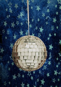 retro disco ball with stars and night sky blue background 