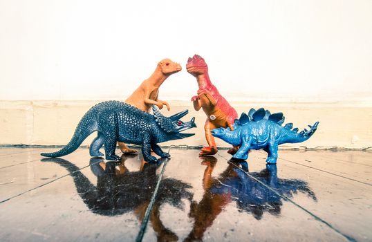 Tyrannosaurus rex and other dinosaurs on a wooden floor with reflection