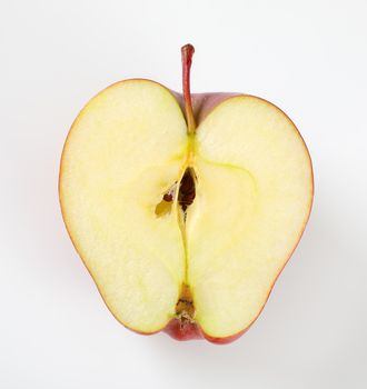 half of red apple on white background