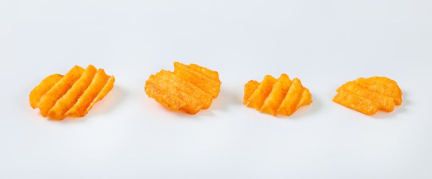 four fried potato chips on white background