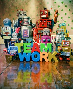 Concept TEAM WORK  wirh wooden letters and vintage robot toys