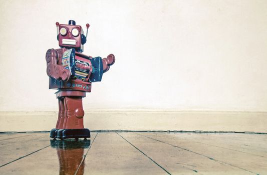 got to go retro red robot on old woden floor with reflection 