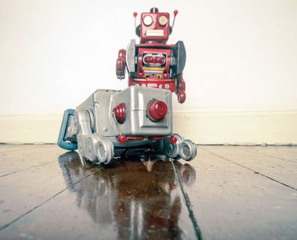 man down r retro obot toy shot down on old wooden floor with reflection 