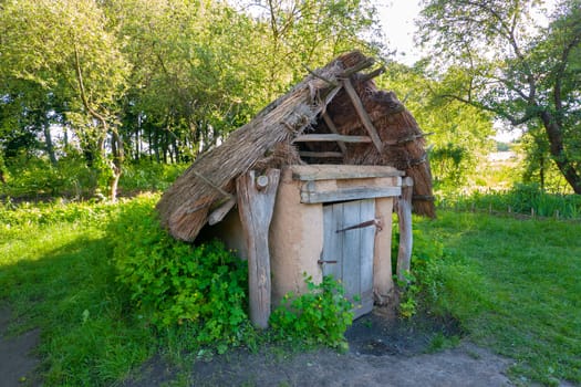 Old cellar in the countryside with green grass