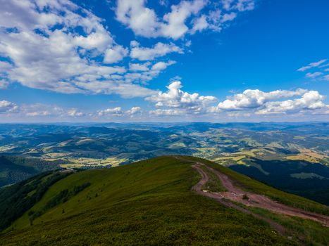 A beautiful mountain landscape against a bright blue cloudy sky. mountains on the horizon