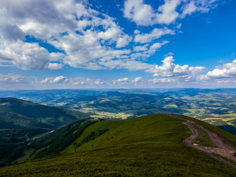 Beautiful Carpathian Mountains against the blue sky with fluffy clouds