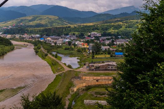 A small village in the middle of a mountain in a valley near a wide river. A good place for tourists and relaxation in the open air
