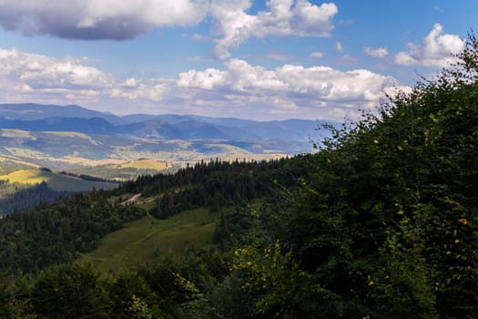 mountain ridge in the Carpathians under the shadows of floating clouds in the sky