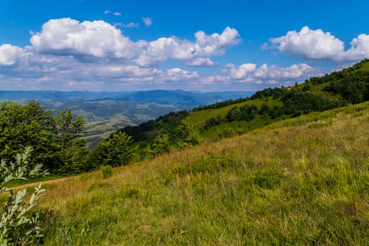 blue of the heavenly ocean with slowly floating clouds over the mountain valleys and peaks